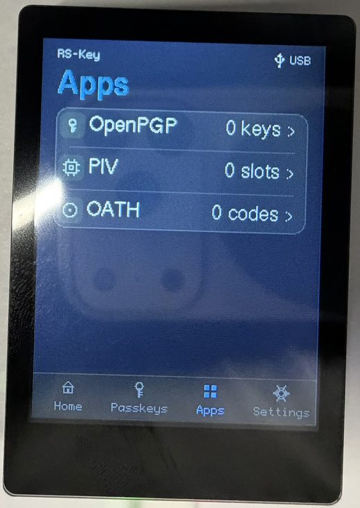 The trusted display’s Apps tab listing three applets as read-only rows: OpenPGP (0 keys), PIV (0 slots) and OATH (0 codes), each with a chevron to drill in