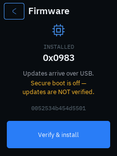 The trusted display’s Firmware screen: the installed build 0x0875 under a chip glyph, “Updates arrive over USB.” and an amber warning that updates are NOT verified, the chip serial, and a blue Verify & install button