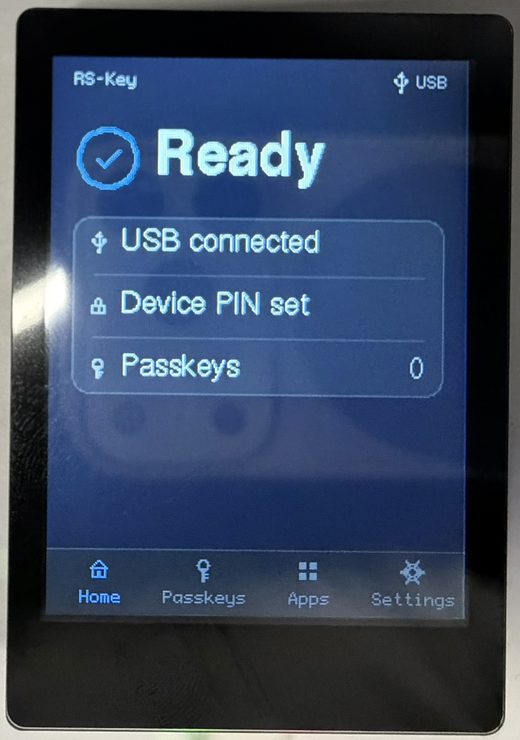 The RS-Key trusted display (Waveshare RP2350-Touch-LCD-2.8) showing its Home screen: a bright “Ready” status beside a check, a status card reading USB connected / Device PIN set / Passkeys 0, and a bottom navigation bar with Home, Passkeys, Apps and Settings tabs