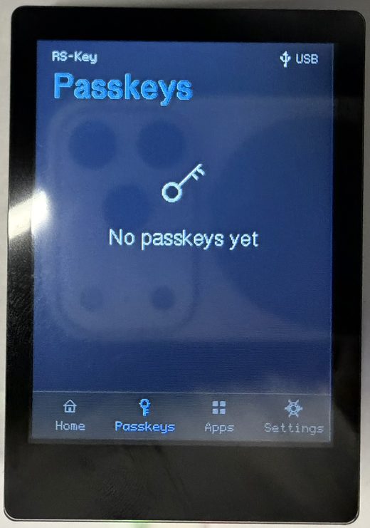 The trusted display’s Passkeys tab on a device with no resident credentials, showing a key glyph and the empty-state message “No passkeys yet”
