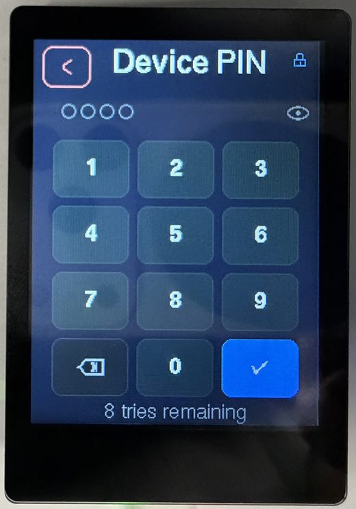 The trusted display’s Device PIN screen: a row of masked entry dots and an eye reveal toggle above a 3×4 numeric keypad (1–9, a backspace key, 0, and a blue confirm key), with “8 tries remaining” beneath
