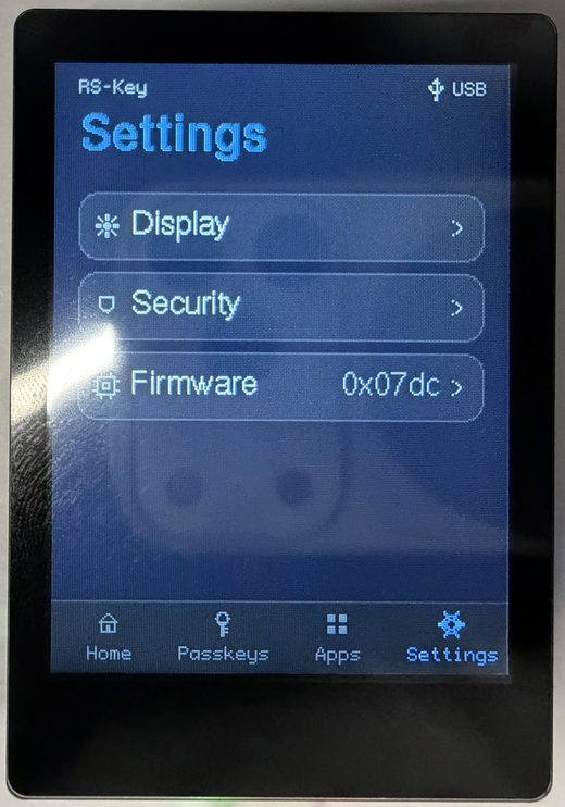 The trusted display’s Settings menu with three entries, Display, Security, and Firmware (showing the running bcdDevice build), above the navigation bar